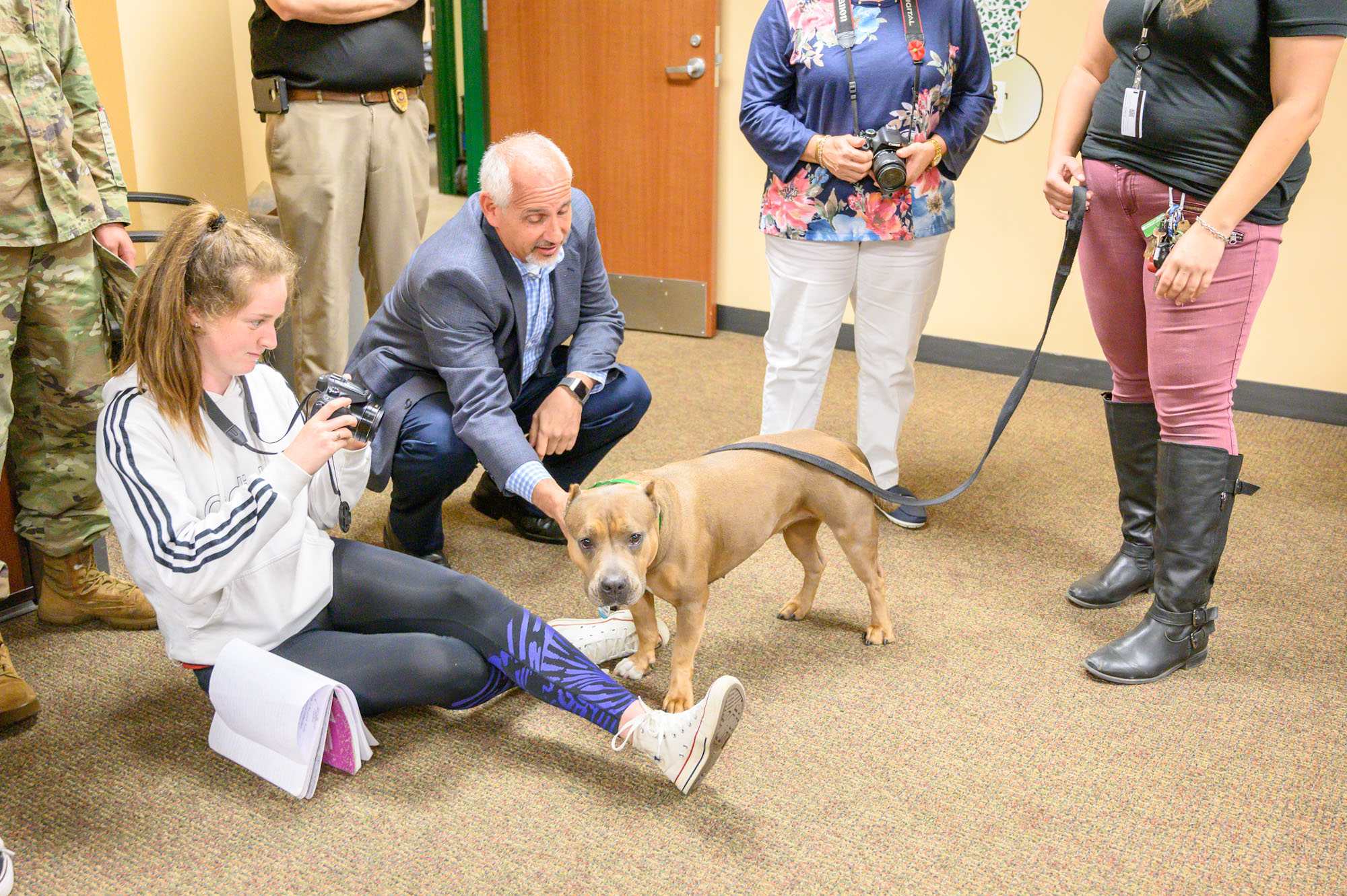 Ken Posner pets dog during Paws of Love presentation_edited